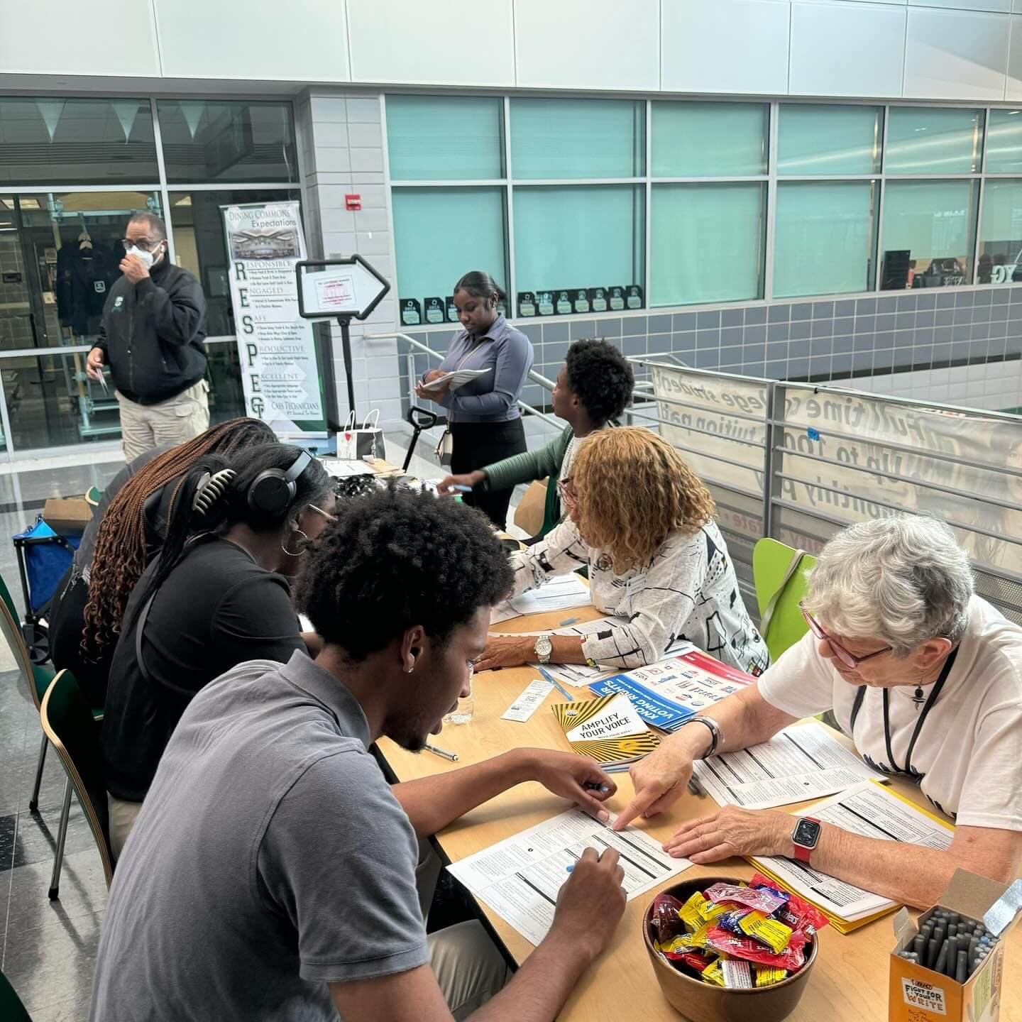 Volunteers assisting attendees with registration paperwork